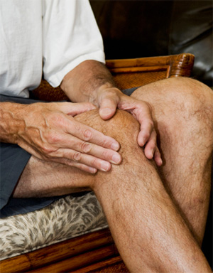 Man massaging his arthritic knee