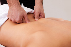 A massage therapist massaging a patient